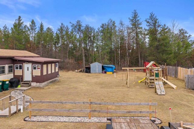 5830 Broadway St, Wisconsin Rapids, WI 54494 - view of yard with fence, entry steps, an outbuilding, and a playground