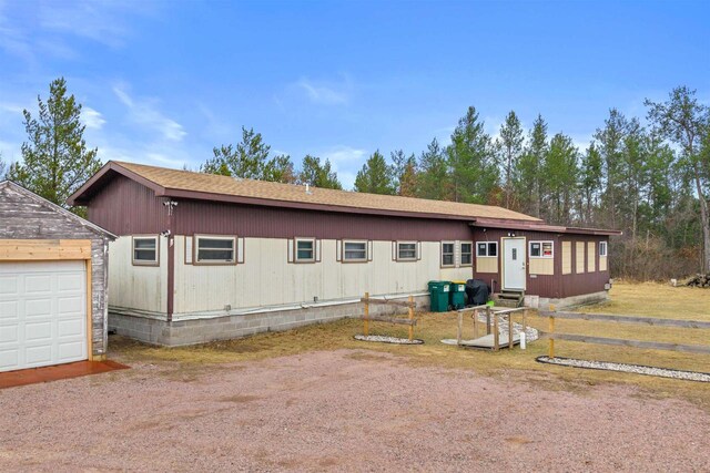 5830 Broadway St, Wisconsin Rapids, WI 54494 - manufactured / mobile home featuring a garage, an outbuilding, and entry steps