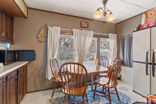 5830 Broadway St, Wisconsin Rapids, WI 54494 - dining space featuring a notable chandelier, light floors, baseboards, and ornamental molding