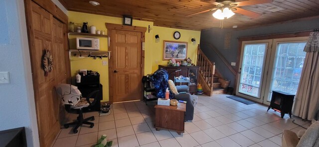 1116 Washington Ave, Stevens Point, WI 54481 - living room featuring light tile patterned flooring, wooden ceiling, stairs, and ceiling fan