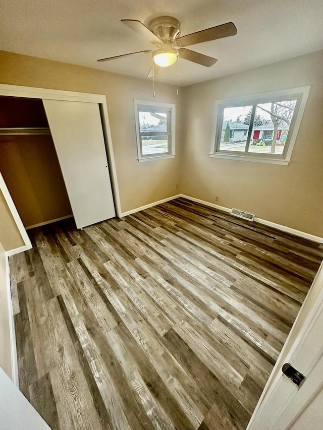 7140 N 48th St, Milwaukee, WI 53223 - unfurnished bedroom featuring ceiling fan, a closet, visible vents, wood finished floors, and baseboards