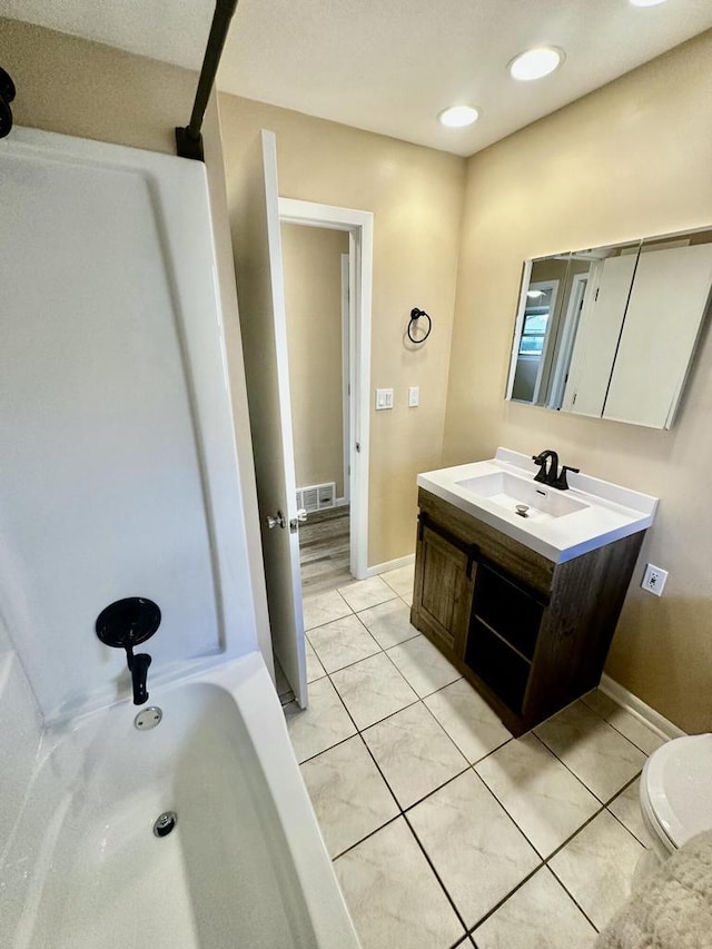 7140 N 48th St, Milwaukee, WI 53223 - full bath featuring visible vents, baseboards, toilet, vanity, and tile patterned flooring