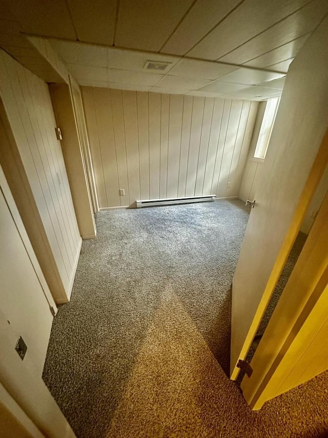 7140 N 48th St, Milwaukee, WI 53223 - below grade area featuring baseboard heating, a paneled ceiling, carpet flooring, and visible vents