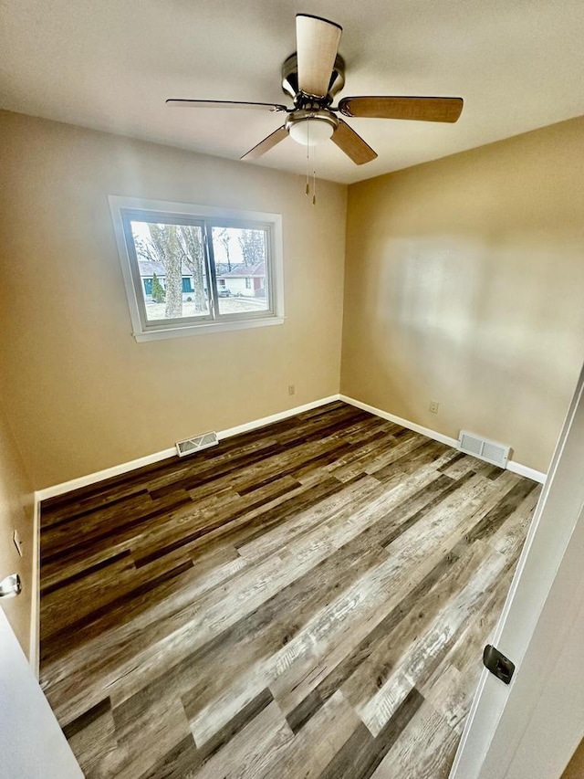 7140 N 48th St, Milwaukee, WI 53223 - unfurnished room with wood finished floors, baseboards, a ceiling fan, and visible vents