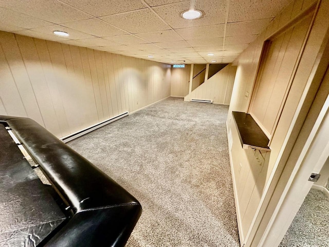 7140 N 48th St, Milwaukee, WI 53223 - finished basement with a baseboard radiator, a paneled ceiling, stairway, carpet flooring, and a baseboard heating unit