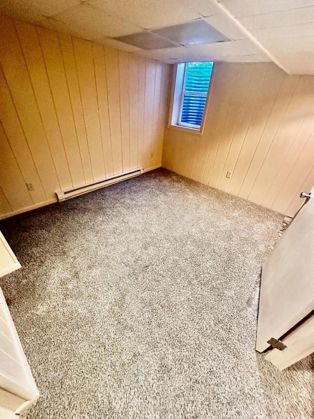7140 N 48th St, Milwaukee, WI 53223 - below grade area with carpet flooring, a baseboard heating unit, and wooden walls