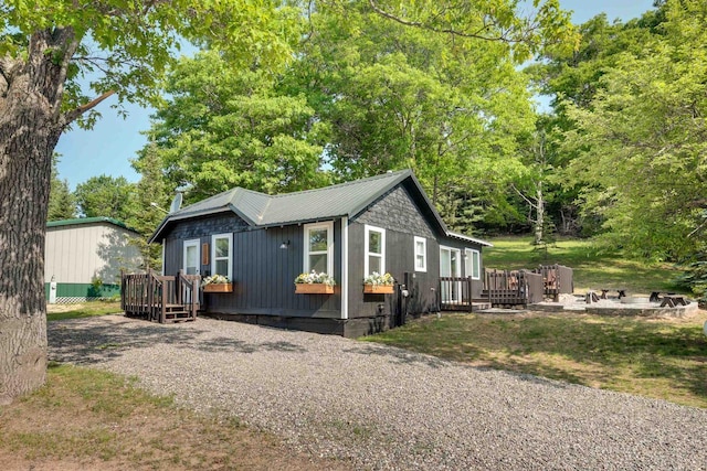 view of front of property with gravel driveway, crawl space, and a deck