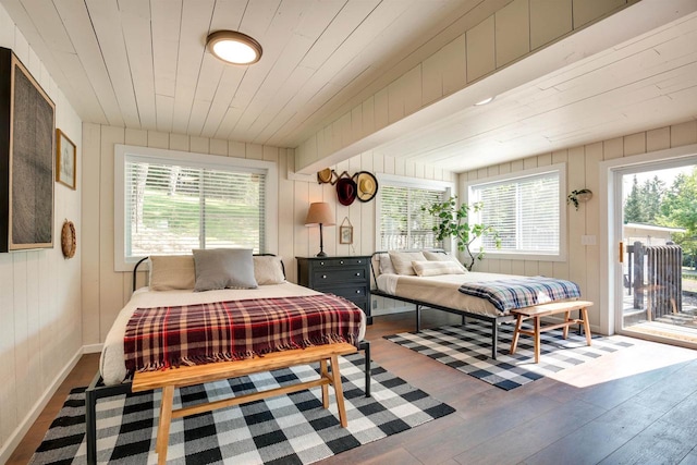 bedroom with wooden ceiling, baseboards, access to outside, and wood finished floors