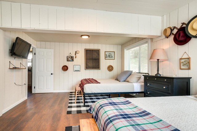 bedroom featuring dark wood-style floors and baseboards