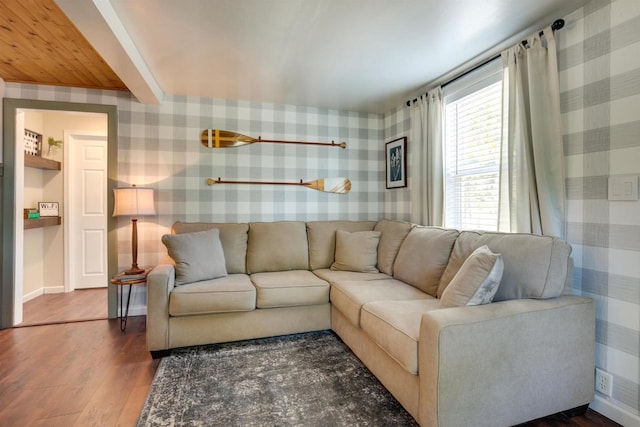 living room with wallpapered walls, baseboards, and wood finished floors