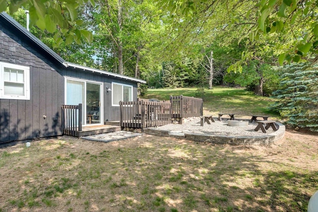 view of yard with a fire pit and a wooden deck