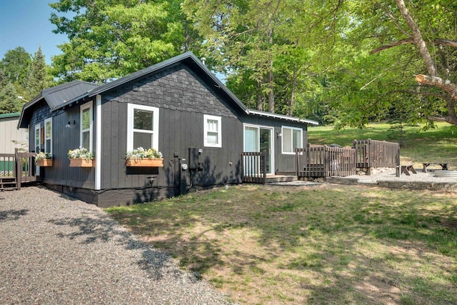 rear view of property with a yard and a deck