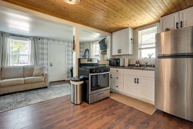 kitchen featuring appliances with stainless steel finishes, dark wood-type flooring, white cabinetry, open floor plan, and wooden ceiling