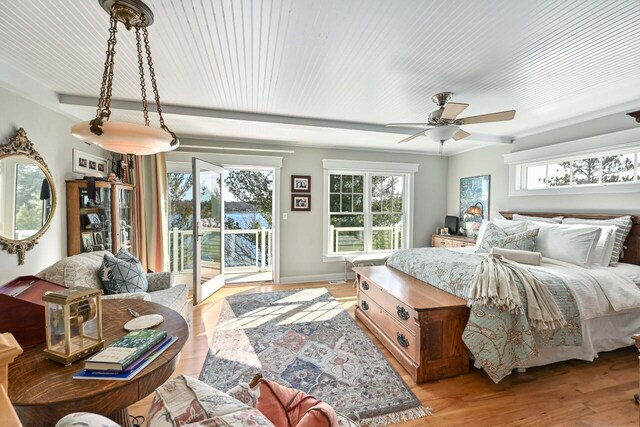 N8512 Booth Lake Heights Rd, East Troy, WI 53120 - bedroom featuring baseboards, access to outside, multiple windows, and light wood-type flooring