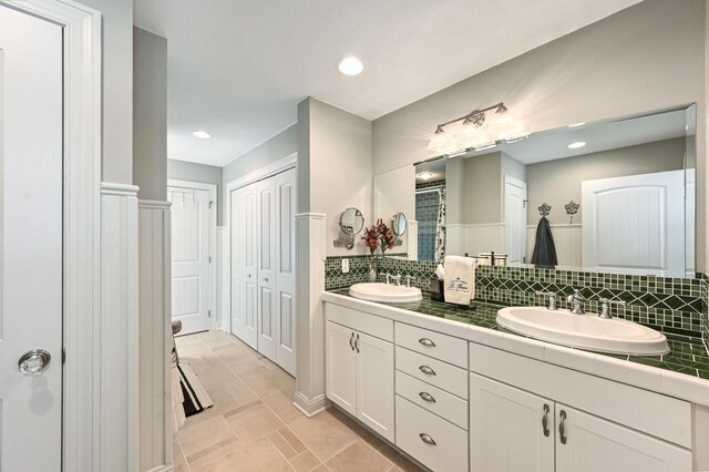 N8512 Booth Lake Heights Rd, East Troy, WI 53120 - bathroom with double vanity, a closet, tasteful backsplash, and a sink