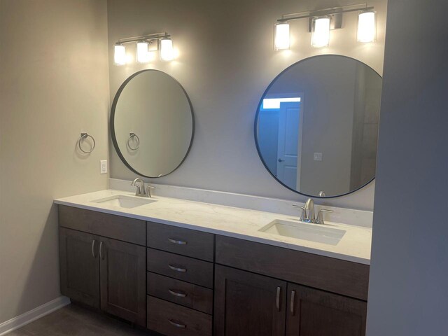 3371 Capellla Ln, Green Bay, WI 54311 - bathroom featuring double vanity, a sink, and baseboards