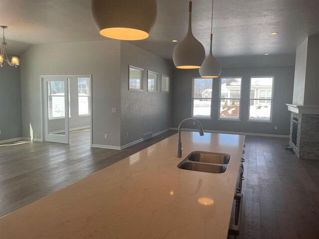 3371 Capellla Ln, Green Bay, WI 54311 - kitchen featuring a sink, a fireplace, dark wood-style floors, open floor plan, and visible vents