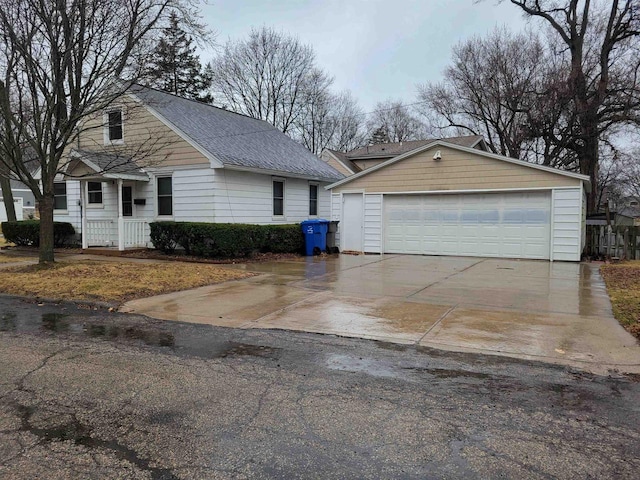 1301 Wyldhaven Ave, Monona, WI 53716 - view of front of home with a shingled roof, a garage, and an outdoor structure
