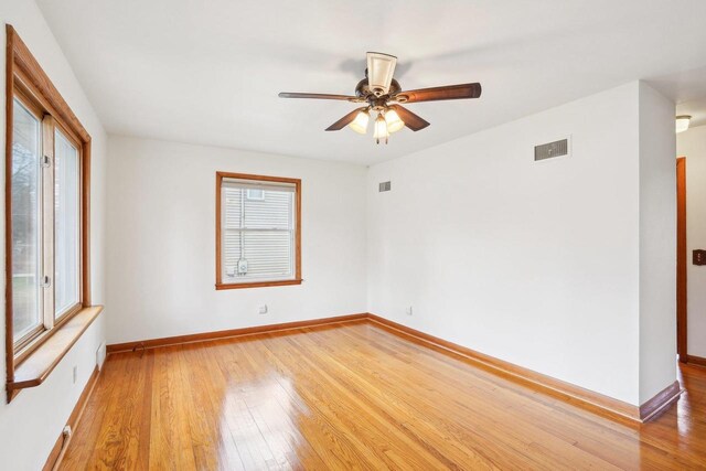 1301 Wyldhaven Ave, Monona, WI 53716 - empty room with visible vents, light wood-style flooring, plenty of natural light, and baseboards