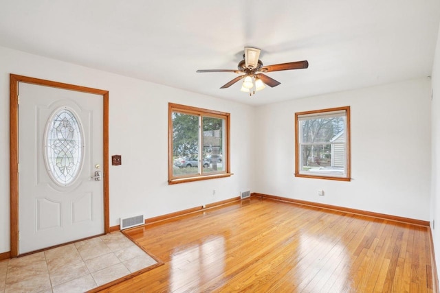 1301 Wyldhaven Ave, Monona, WI 53716 - entrance foyer with visible vents, ceiling fan, light wood finished floors, and a wealth of natural light
