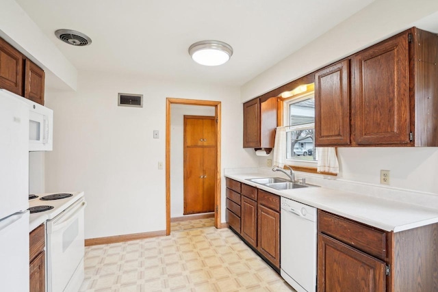 1301 Wyldhaven Ave, Monona, WI 53716 - kitchen with white appliances, visible vents, a sink, and light floors