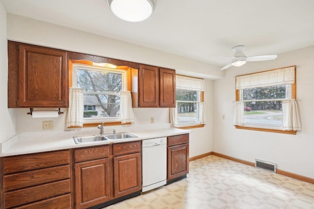 1301 Wyldhaven Ave, Monona, WI 53716 - kitchen featuring visible vents, dishwasher, a sink, light countertops, and light floors