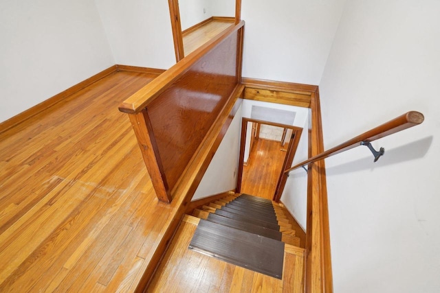 1301 Wyldhaven Ave, Monona, WI 53716 - stairs featuring wood-type flooring and baseboards