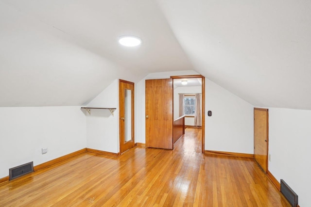 1301 Wyldhaven Ave, Monona, WI 53716 - additional living space with visible vents, baseboards, hardwood / wood-style floors, and lofted ceiling