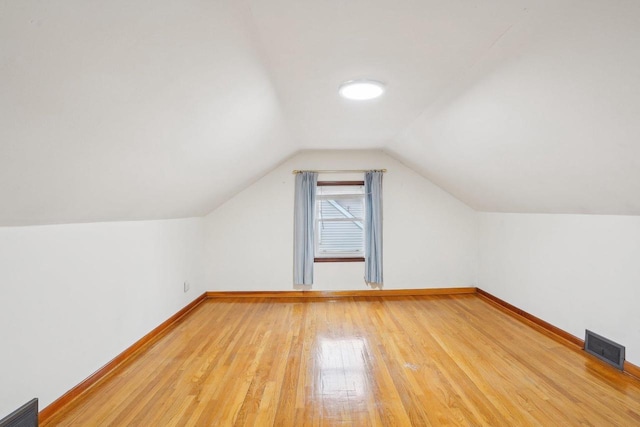 1301 Wyldhaven Ave, Monona, WI 53716 - bonus room with light wood finished floors, baseboards, lofted ceiling, and visible vents