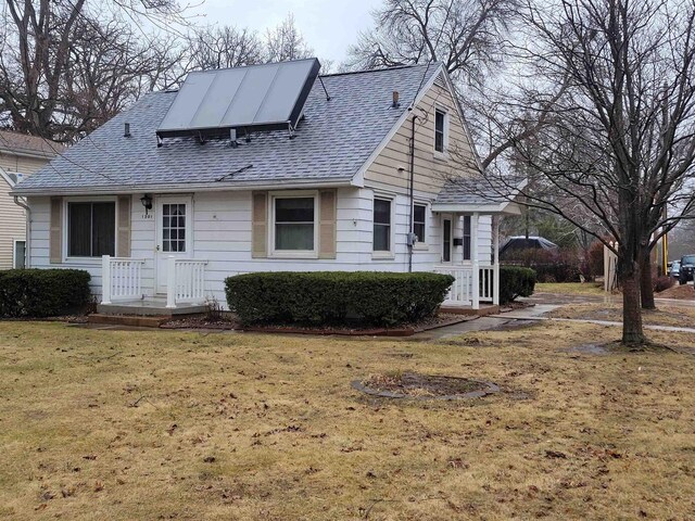 1301 Wyldhaven Ave, Monona, WI 53716 - view of front of house with roof with shingles and a front lawn