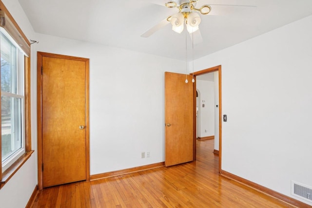 1301 Wyldhaven Ave, Monona, WI 53716 - empty room with visible vents, baseboards, light wood-style flooring, and ceiling fan