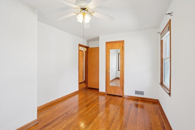 1301 Wyldhaven Ave, Monona, WI 53716 - empty room with light wood-style flooring, baseboards, a ceiling fan, and visible vents