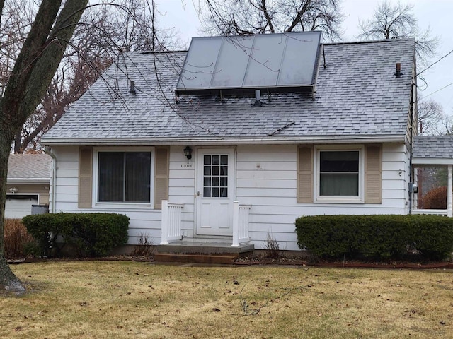 1301 Wyldhaven Ave, Monona, WI 53716 - view of front facade with a shingled roof and a front yard