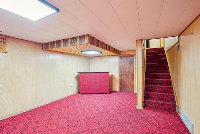 1301 Wyldhaven Ave, Monona, WI 53716 - finished basement featuring wooden walls, visible vents, and stairway