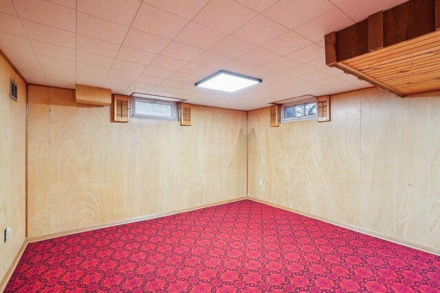 1301 Wyldhaven Ave, Monona, WI 53716 - basement featuring wood walls, visible vents, and baseboards