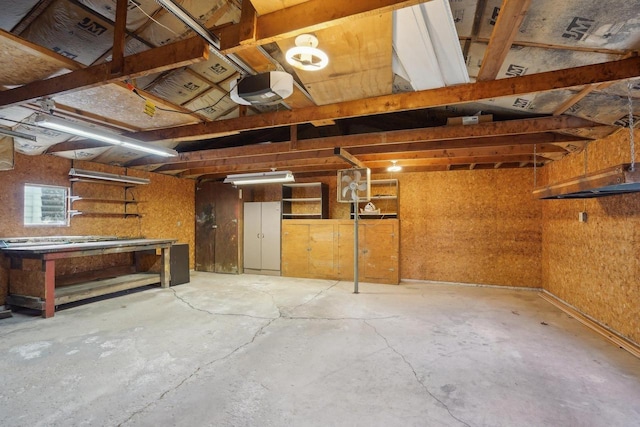 1301 Wyldhaven Ave, Monona, WI 53716 - garage with a garage door opener and a workshop area