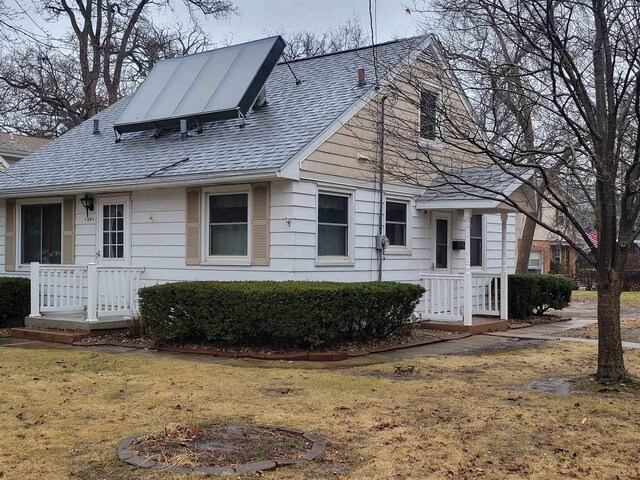 1301 Wyldhaven Ave, Monona, WI 53716 - view of front of house with a front yard and a shingled roof