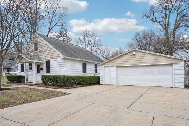 1301 Wyldhaven Ave, Monona, WI 53716 - view of side of home featuring roof with shingles, a detached garage, and an outdoor structure