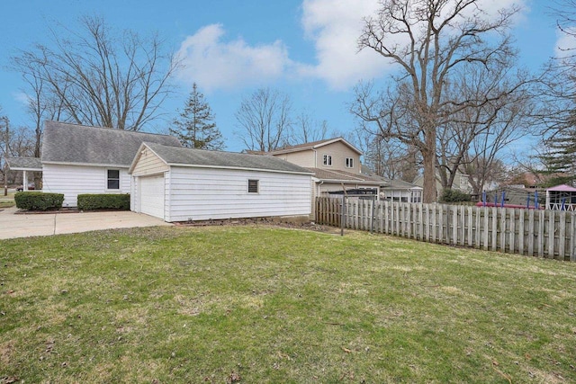 1301 Wyldhaven Ave, Monona, WI 53716 - view of yard featuring an outdoor structure, fence, and concrete driveway