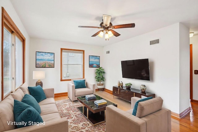 1301 Wyldhaven Ave, Monona, WI 53716 - living room with a healthy amount of sunlight, wood finished floors, a ceiling fan, and visible vents