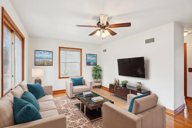 1301 Wyldhaven Ave, Monona, WI 53716 - living area with visible vents, a ceiling fan, wood finished floors, and a healthy amount of sunlight