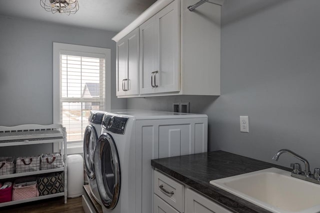 clothes washing area featuring cabinet space, washer and clothes dryer, and dark wood-type flooring