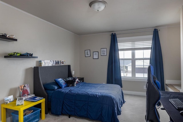 bedroom with light carpet, ornamental molding, baseboards, and an office area