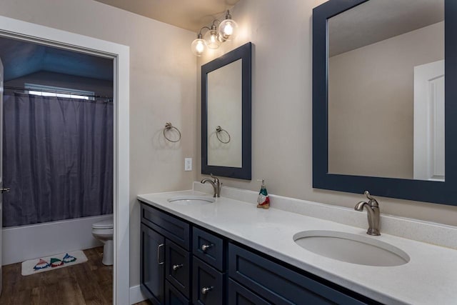 full bath with wood finished floors, toilet, double vanity, and shower / tub combo