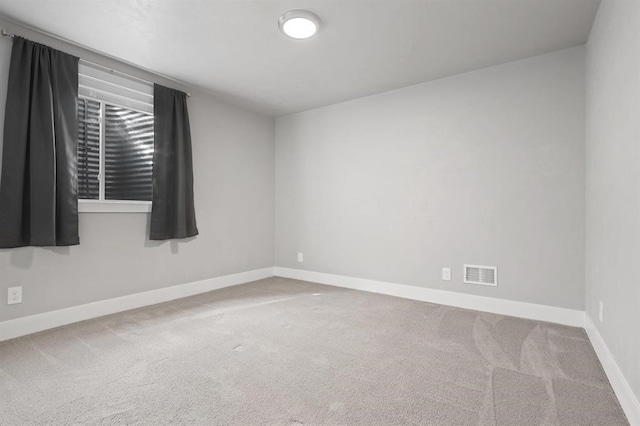unfurnished room with carpet flooring and baseboards
