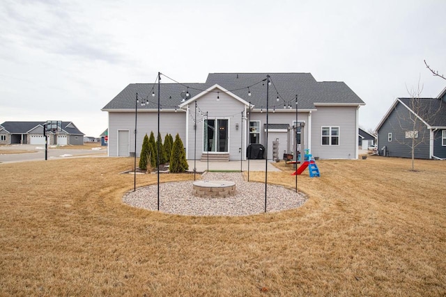 rear view of property with a patio and a yard