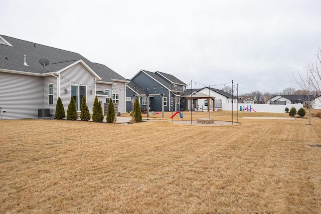 view of green lawn with central air condition unit, a residential view, and a gazebo