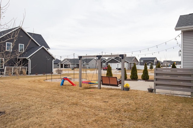 view of jungle gym featuring a residential view and a yard
