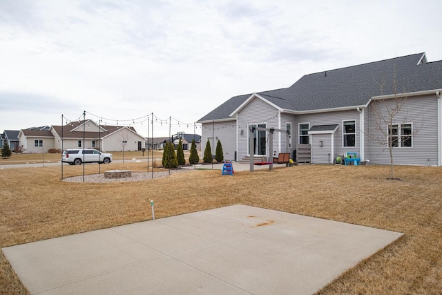 view of basketball court with a lawn and a residential view