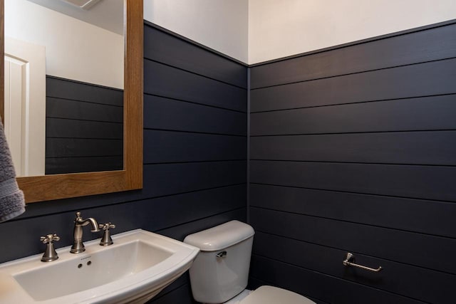 half bath featuring a sink and toilet